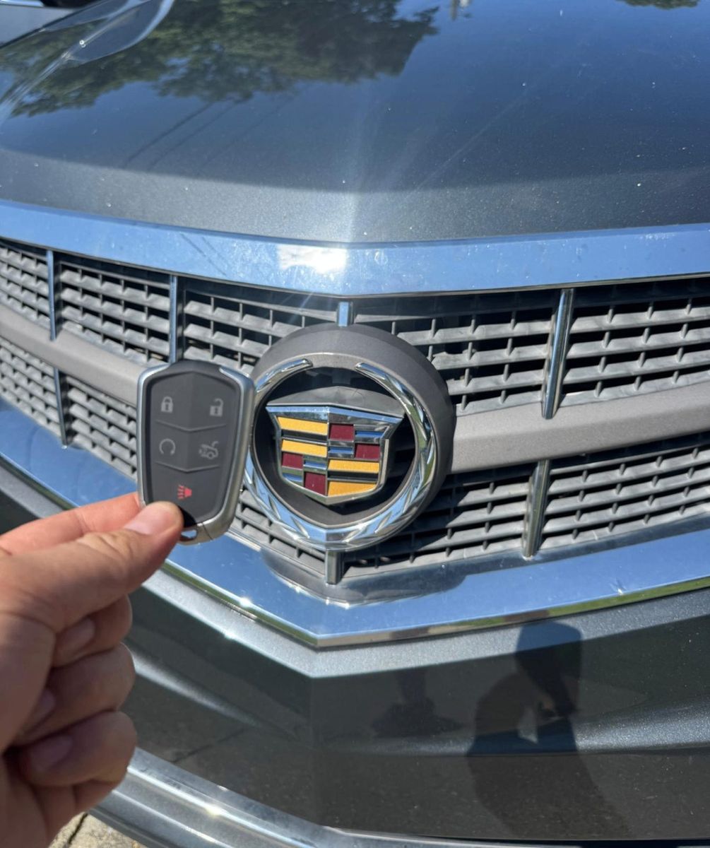 Cadillac smart key replaced and paired in a PGA Village driveway by St Lucie Lock and Key.